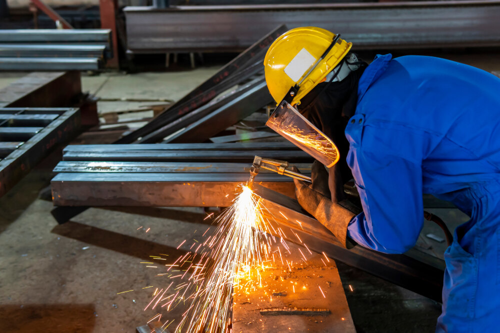 M&N artisan cutting structural steel — fabrication in progress
